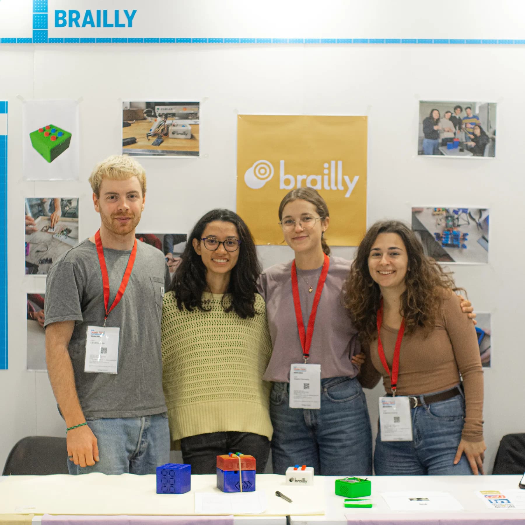 The Brailly team standing behind several generations of tactile prototypes at Maker Faire